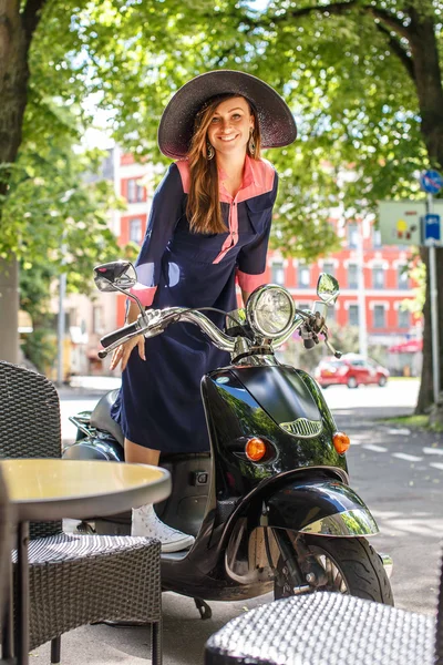 Fashin girl sitting on street scooter. — Stockfoto