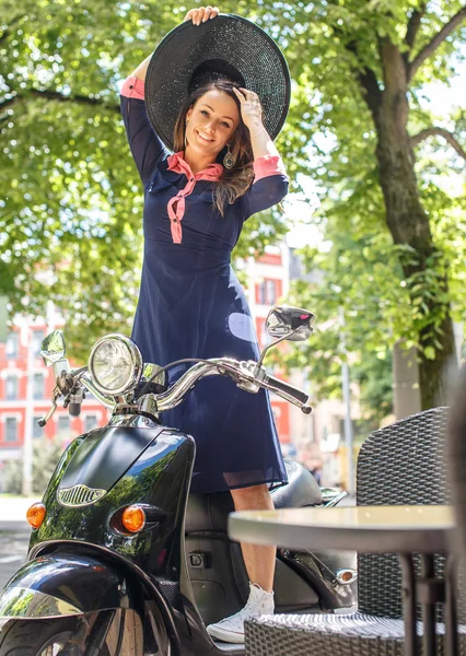 Fashin girl sitting on street scooter. — Zdjęcie stockowe