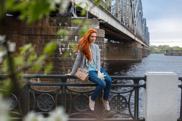 Rödhårig casual flicka poserar nära big river. — Stockfoto