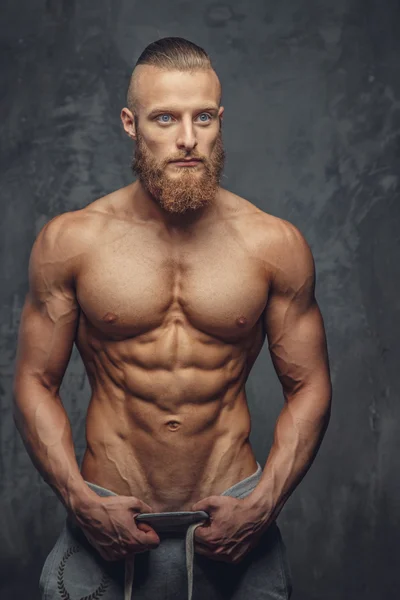 Homem musculoso com barba mostrando seu grande corpo . — Fotografia de Stock