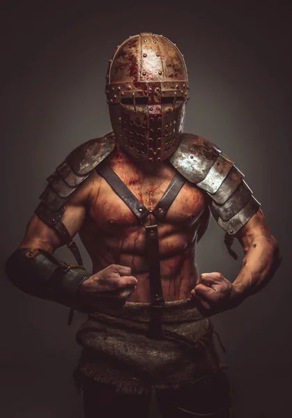 Angry bloody gladiator in helmet — Stock Photo, Image