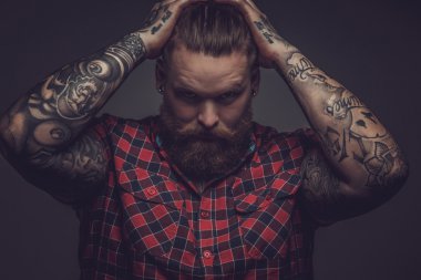 Brutal guy with beard and tattooes. clipart