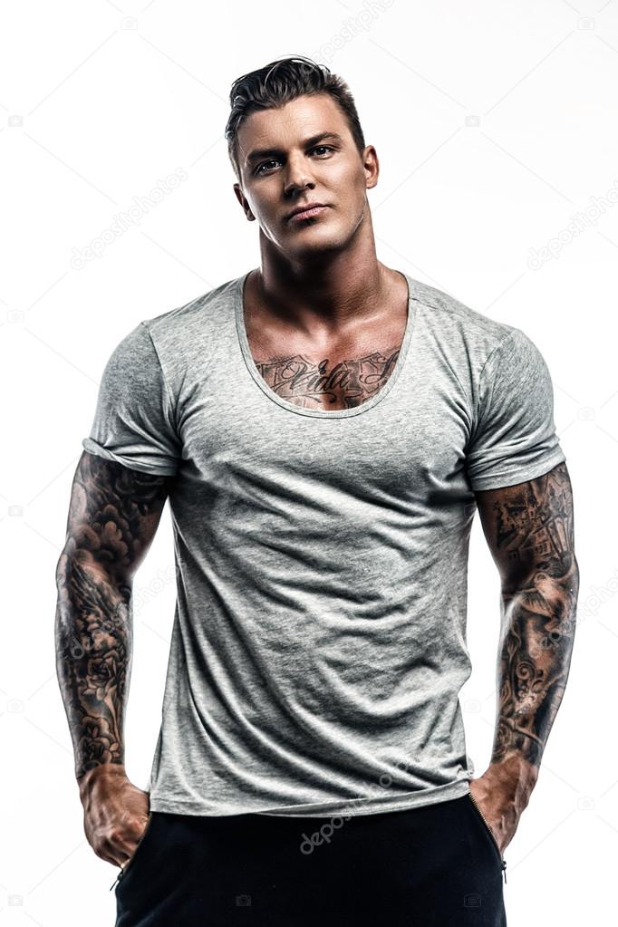 Tattooed man in grey t shirt.
