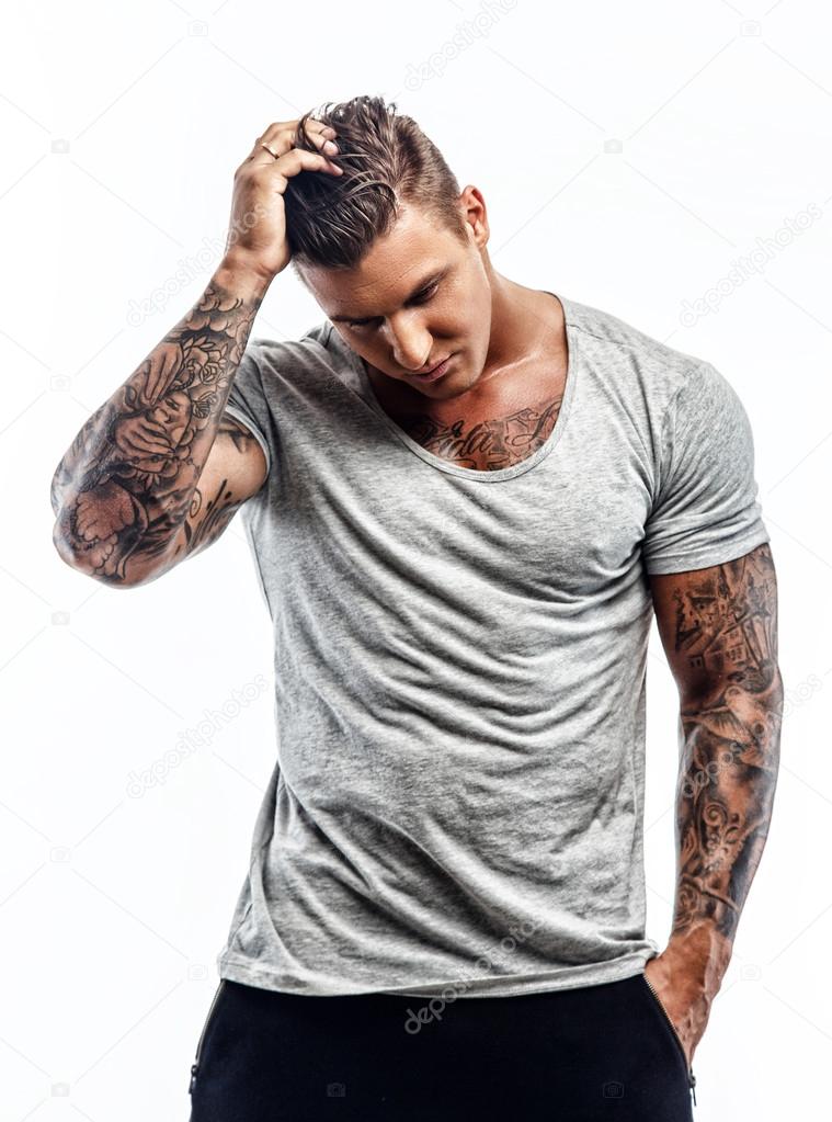 Tattooed man in grey t shirt.