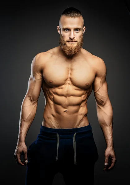 Athletic muscular bearded guy. — Stock Photo, Image