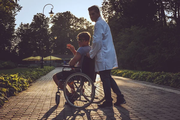 Genç adam tekerlekli sandalyede. — Stok fotoğraf