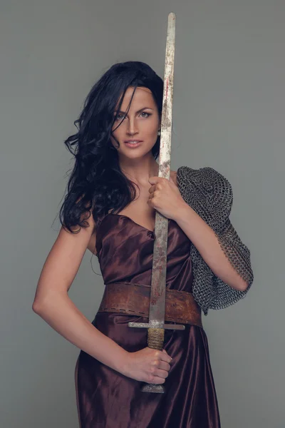 Beautiful brunette woman in ancient dress. — Stock Photo, Image