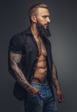 Fashionable tatooed man with beard. clipart