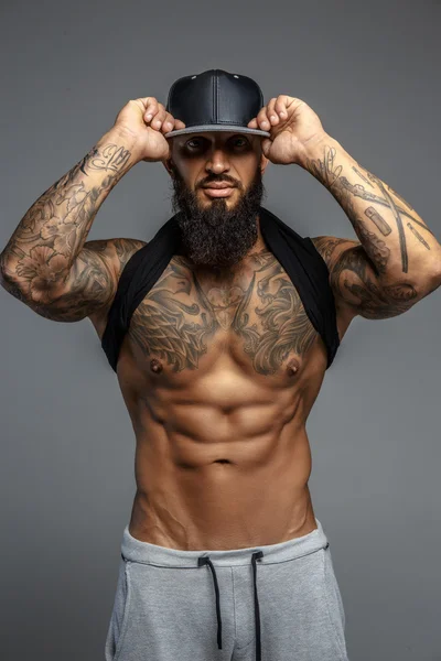 Brutal tatoué homme en casquette noire . — Photo