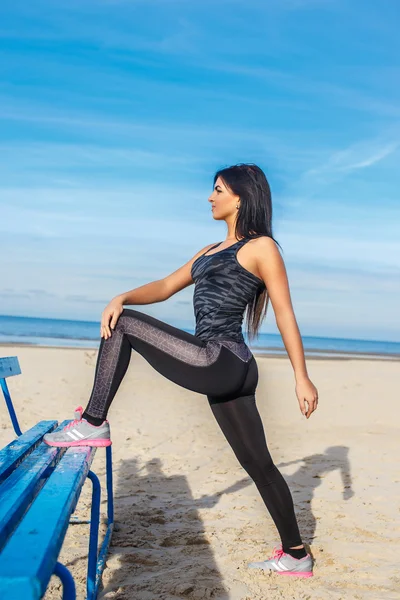 Flexible brunette woman in sportswear. — Stock Photo, Image