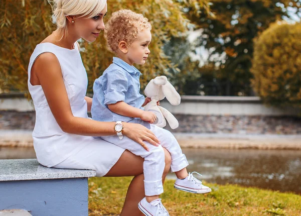 Little boy sitting on his mother — Stock Photo, Image