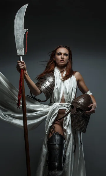 Woman with sword in white fluttering dress. — Stock Photo, Image