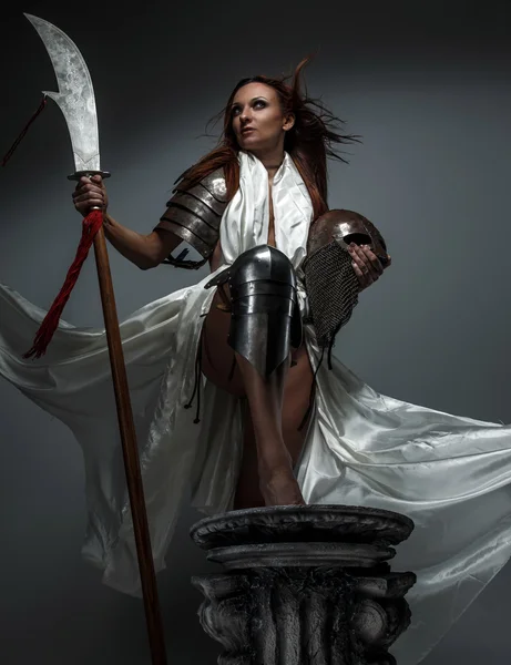Woman with sword in white fluttering dress. — Stock Photo, Image