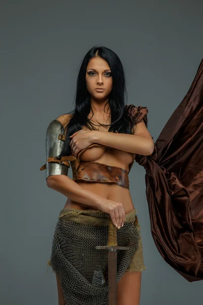 Sexy brunette woman in roman armor. — Stock Photo, Image