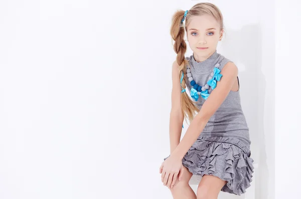 Cute little girl in grey dress. — Stock Photo, Image