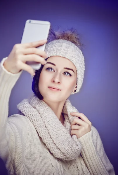 Mulher de camisola e chapéu de inverno tomando selfie . — Fotografia de Stock