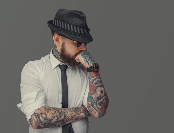 Człowiek z tatuażem ramiona myśląc. — Zdjęcie stockowe