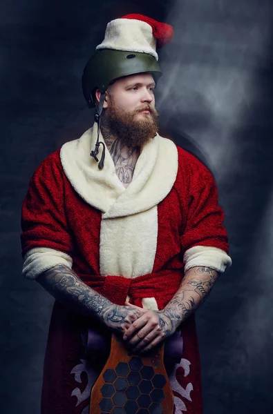 Bearded skater boy in Santa's clothes — Stock Photo, Image