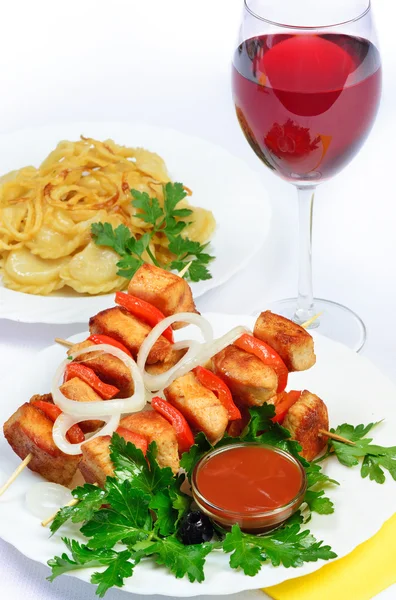 Table with food of meat on skewer, dumplings and gass of red win — Stock Photo, Image