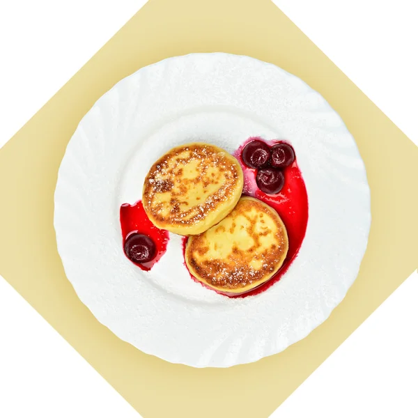 Dish of pancakes with cherry sause on white plate. — Stock Photo, Image