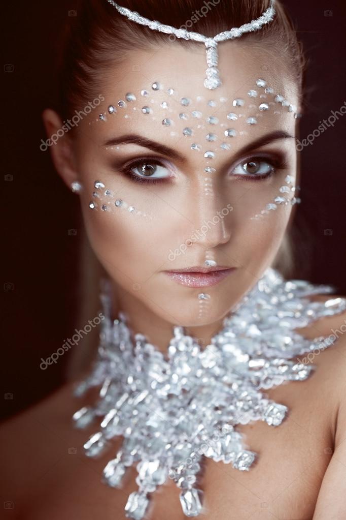 Beauty woman makeup with crystals on face, black background — Stock