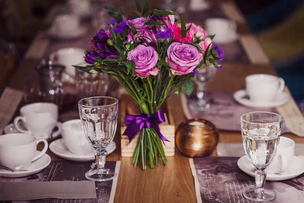 Composição de flores em restaurante, rosas e íris, tons de combinação de roxo — Fotografia de Stock