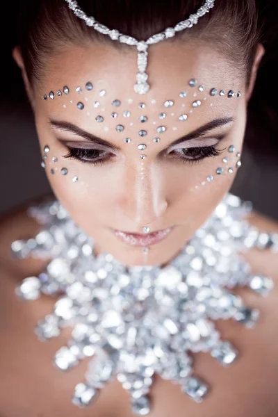 Beauty woman makeup with crystals on face, looking down — Stock Photo, Image