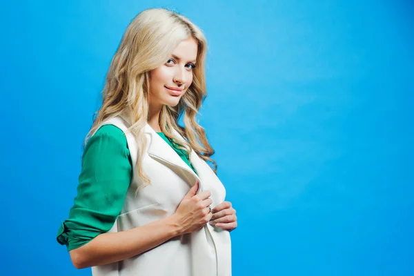 Portrait of young confident blonde, casual style, blue background Royalty Free Stock Images