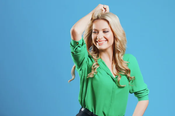 Portrait of young happy blonde, casual style, blue background Stock Photo