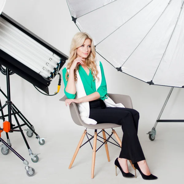 Young beautiful woman in Studio, lighting spotlights on the background — Stock Photo, Image