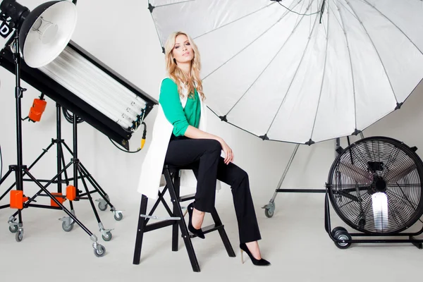 Young beautiful woman in Studio, lighting spotlights on the background — Stock Photo, Image