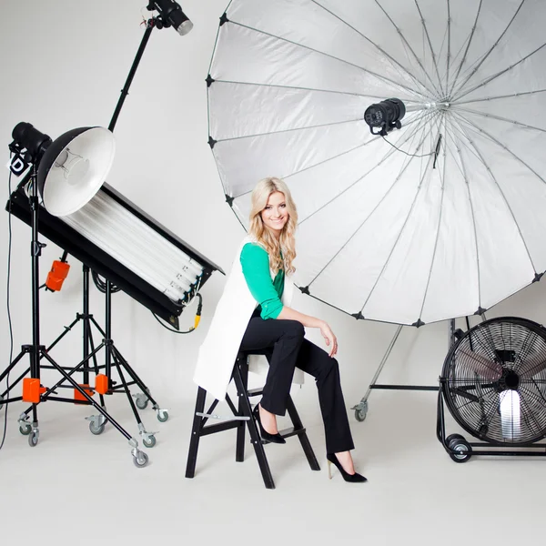 Young beautiful woman in Studio, lighting spotlights on the background — Stock Photo, Image