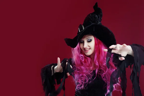 Attractive woman in witches hat and costume with red hair. Halloween — Stock Photo, Image