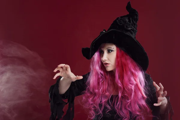 Attractive woman in witches hat and costume with red hair. Halloween — Stock Photo, Image