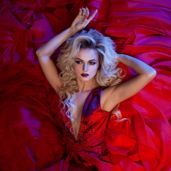 Fashion photo of young magnificent woman in red dress. Studio portrait — Stock Photo, Image