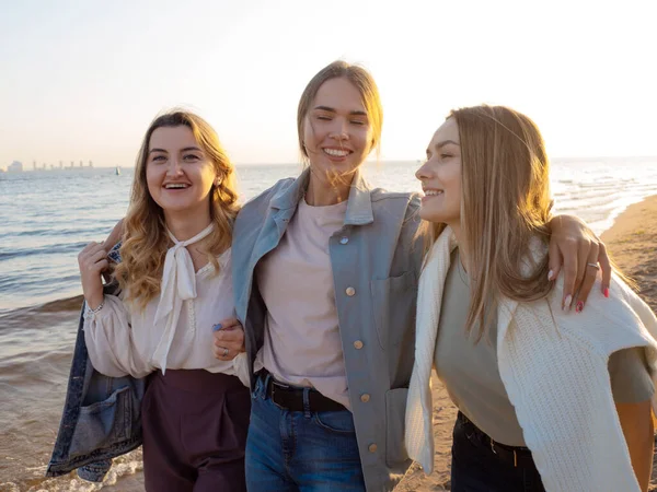 Drei Freunde amüsieren sich am Strand, treffen Freunde. Junge Frauen — Stockfoto