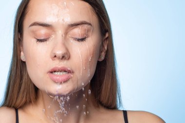 Clean skin, drops and trickles of water on the face. Young beautiful woman, clipart