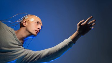 Beyninde elektrotlar olan kel bir adam, fütüristik bir kavram.,