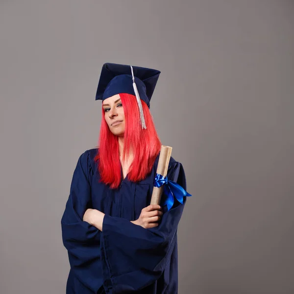 young woman is a university graduate. Happy graduate master in a robe and cap,