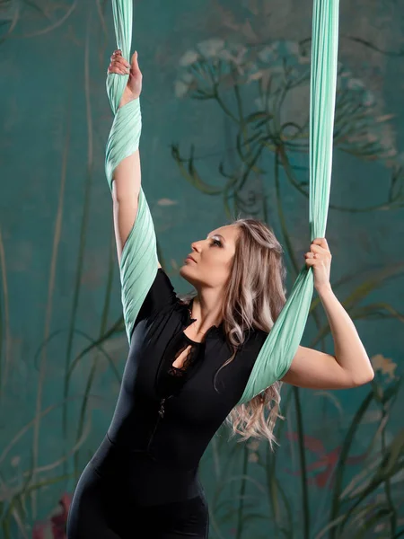 Portrait of a young female athlete who is engaged in aero yoga — Stock Photo, Image