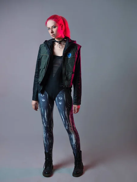 Futuristic fashion, a young bright and attractive woman with pink hair, — Stock Photo, Image