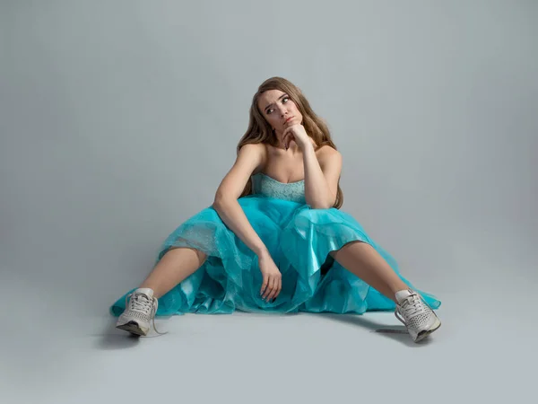 Cheerful princess in a lush blue dress and sneakers, modern style. — Stock Photo, Image