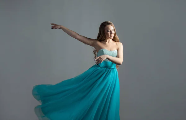 Prachtige dansende prinses in een weelderige blauwe jurk, een jonge mooie blonde — Stockfoto