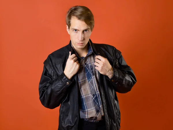A guy in a casual plaid shirt and a leather jacket, studio photo — Stock Photo, Image