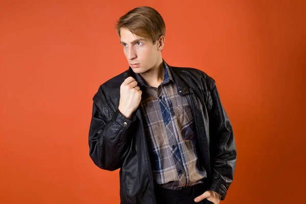 A guy in a casual plaid shirt and a leather jacket, studio photo — Stock Photo, Image