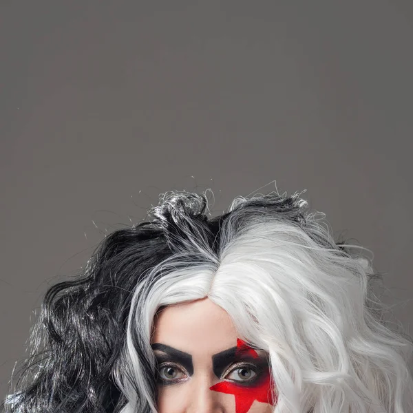 Mujer joven impactante divertida en maquillaje brillante y con peinado blanco y negro. — Foto de Stock