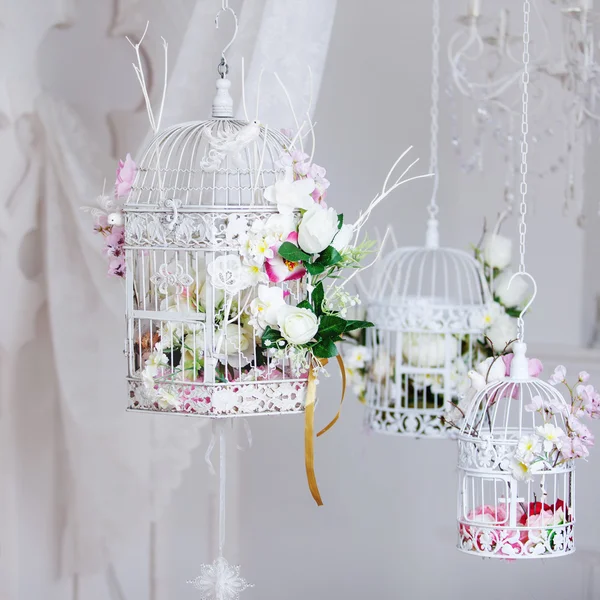 Gaiola decorativa branca com belas flores, células de suspensão — Fotografia de Stock