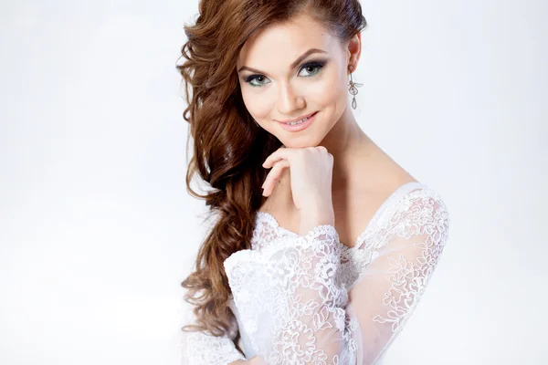 Portrait of happy bride in wedding dress, white background — Stock Photo, Image