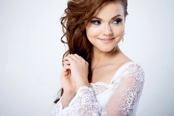 Portrait of happy bride in wedding dress, white background — Stock Photo, Image