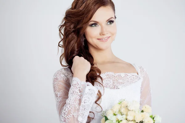 Portret van gelukkige bruid in trouwjurk, witte achtergrond — Stockfoto
